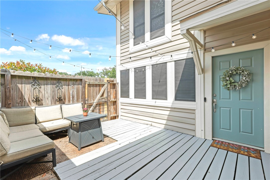 a balcony with wooden floor and outdoor seating