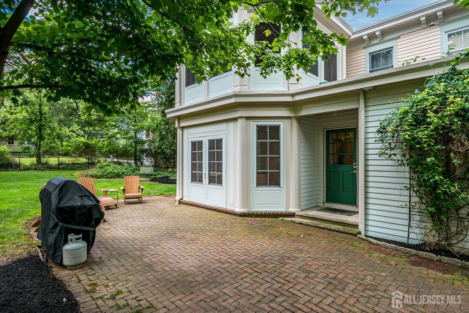 44 Rector Street Metuchen, NJ 08840 - Photo 14 of 65 a view of a chair and table in the back yard of the house