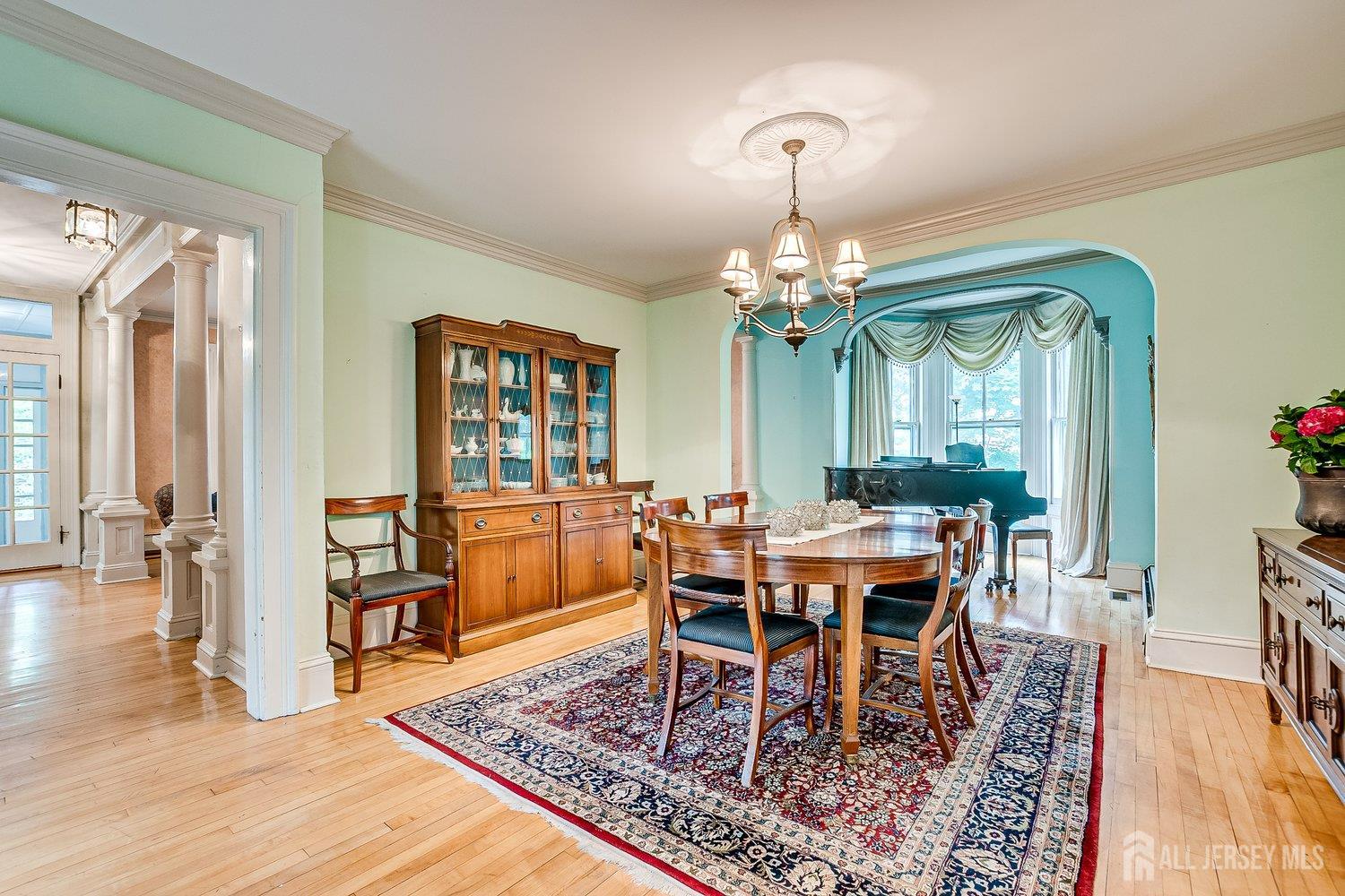 44 Rector Street Metuchen, NJ 08840 - Photo 3 of 65 a dining room with wooden floor a chandelier a wooden table and chairs