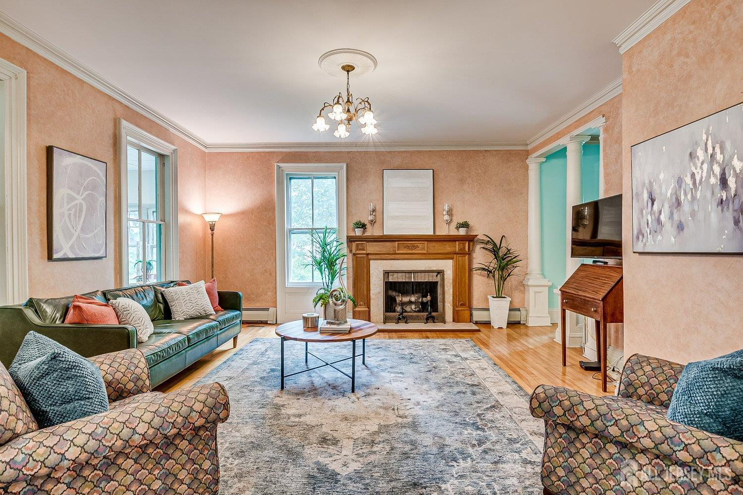 44 Rector Street Metuchen, NJ 08840 - Photo 33 of 65 a living room with furniture a chandelier and a fireplace