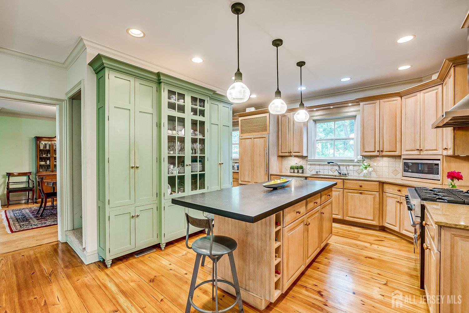 44 Rector Street Metuchen, NJ 08840 - Photo 39 of 65 a kitchen with stainless steel appliances granite countertop a stove a sink dishwasher and a refrigerator with wooden floor