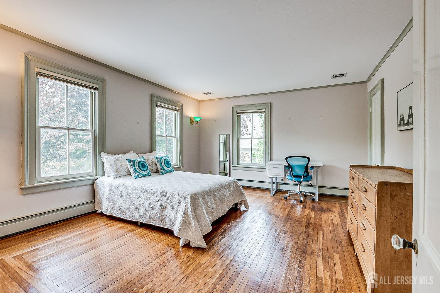 44 Rector Street Metuchen, NJ 08840 - Photo 57 of 65 a bedroom with a bed and wooden floor