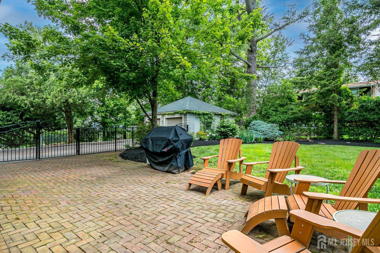 44 Rector Street Metuchen, NJ 08840 - Photo 9 of 65 a view of backyard with a table and chairs under an umbrella