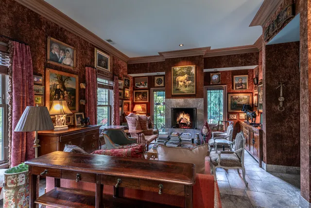 a living room with furniture a table and a fireplace