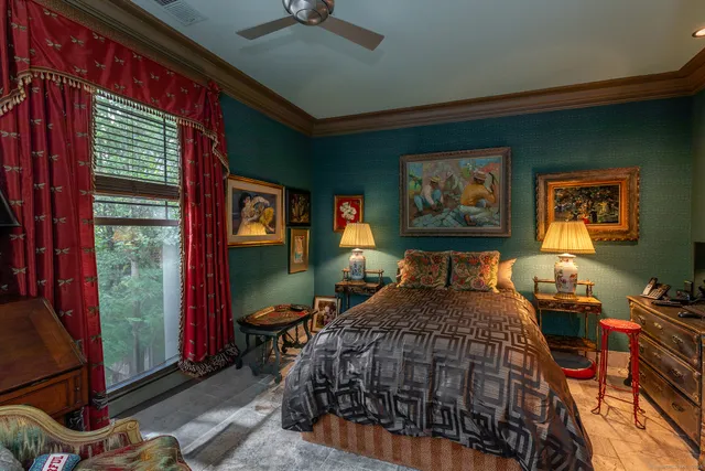 a bedroom with a bed a dresser next to a window