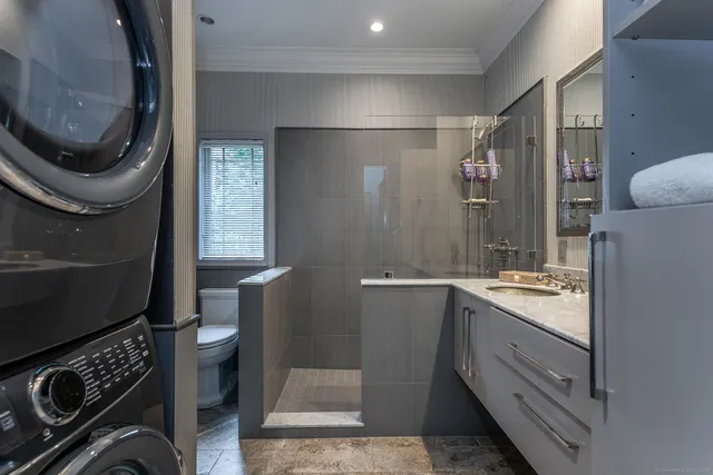 a bathroom with a sink a toilet and a mirror