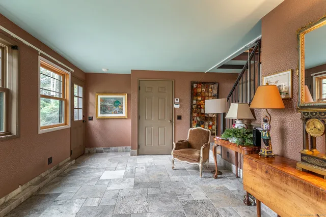 a living room with furniture a window and a table