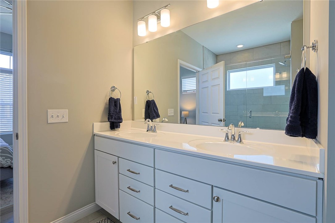 5013 Arena Court Hamilton, OH 45011 - Photo 23 of 41 This spacious primary bathroom features a dual vanity and an expansive mirror.