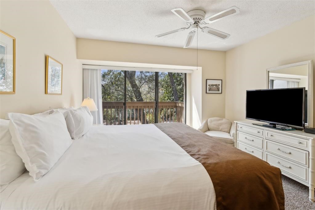 2004 Beachwood Road, Unit 2004 Fernandina Beach, FL 32034 - Photo 29 of 54 a bedroom with a bed and a flat screen tv