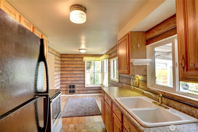a view of front door with wooden floor and a window