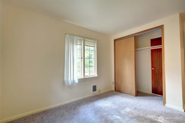 a living room with a couch and a rug