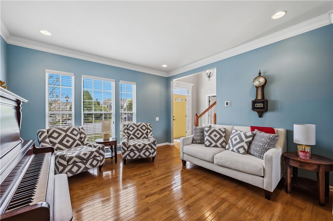9031 Pathfinder Road Breinigsville, PA 18031 - Photo 8 of 63 Hardwood floors and generous windows create a light-filled and inviting gathering space.
