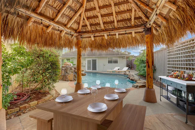 a view of yard from deck with patio