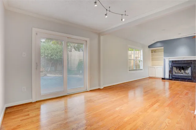 a view of empty room with window and fireplace