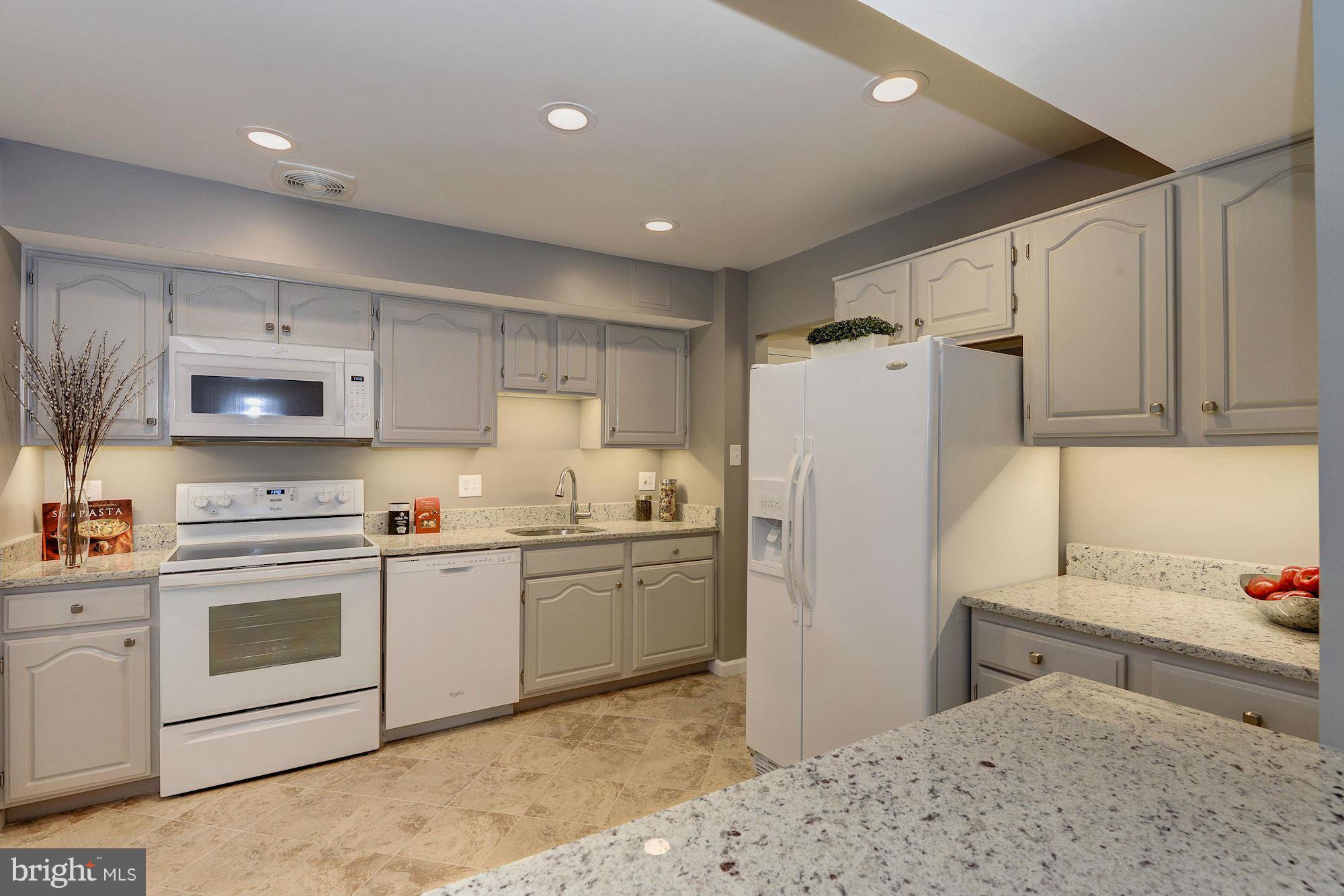 a kitchen with cabinets and stainless steel appliances