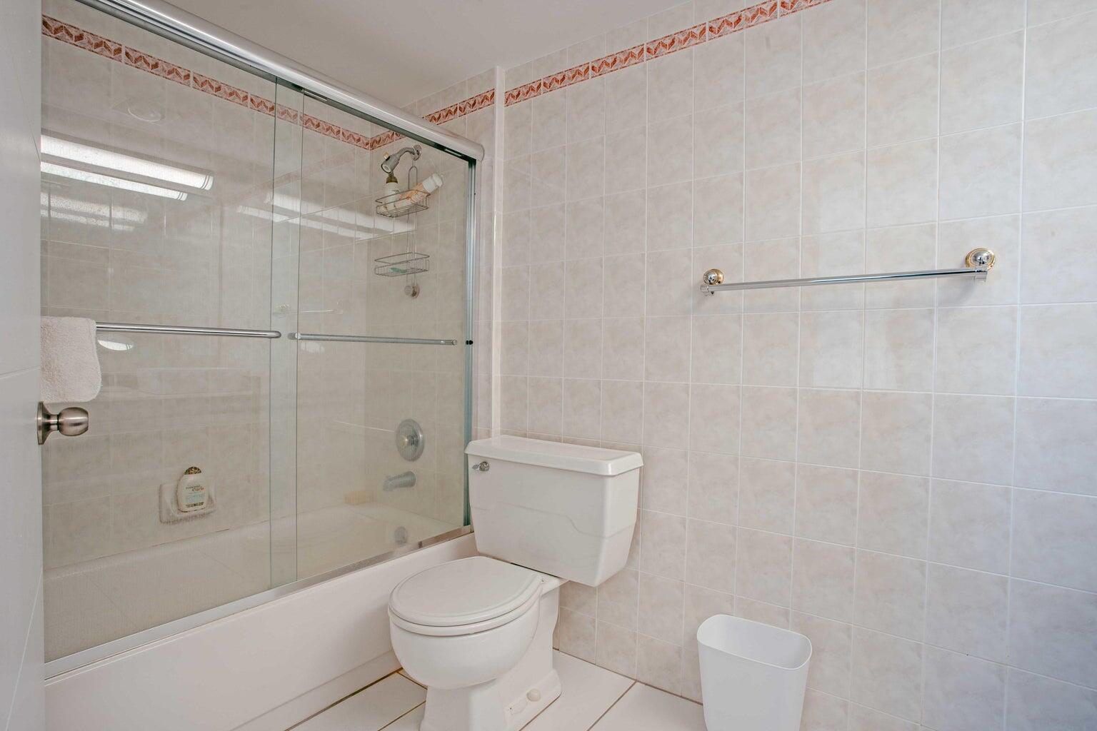 5500 Old Ocean Boulevard, Unit 210 Ocean Ridge, FL 33435 - Photo 19 of 27 a bathroom with a shower a toilet and a sink