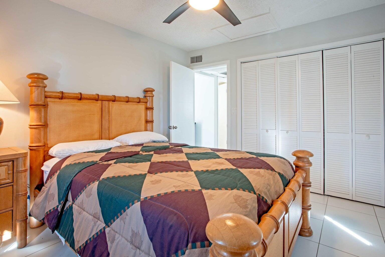 5500 Old Ocean Boulevard, Unit 210 Ocean Ridge, FL 33435 - Photo 20 of 27 a bedroom with a bed and a chandelier