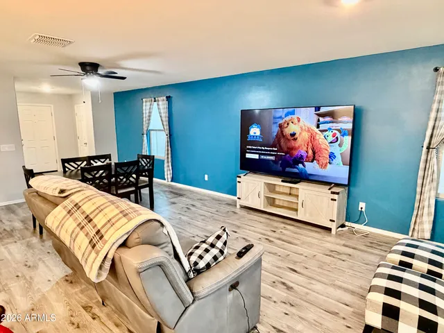a bedroom with furniture and a flat screen tv
