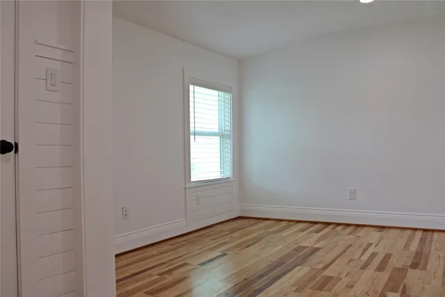 a view of a room with wooden floor