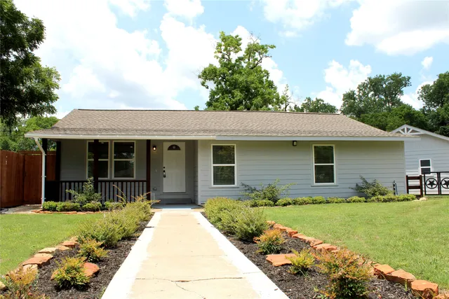 a view of a yard with wooden fence
