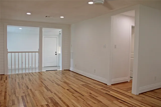 a view of hallway with wooden floor