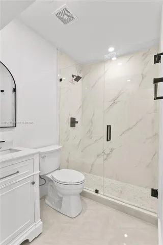 a bathroom with a toilet sink and a shower