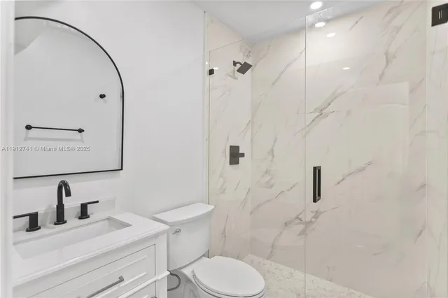 a bathroom with a sink toilet and shower