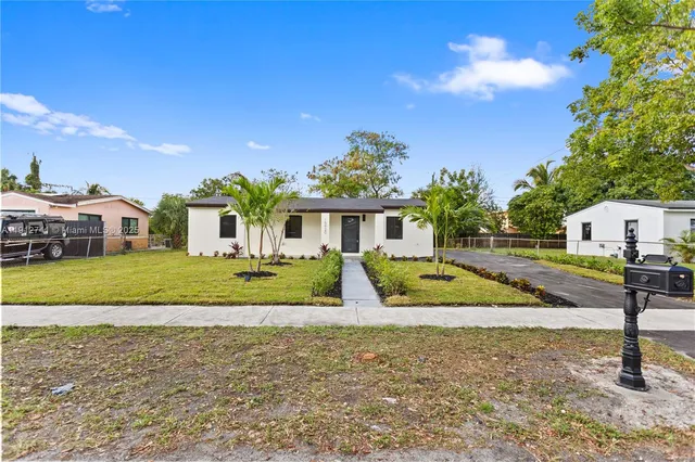 a view of house with outdoor space and swimming pool