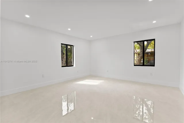 a view of an empty room with windows