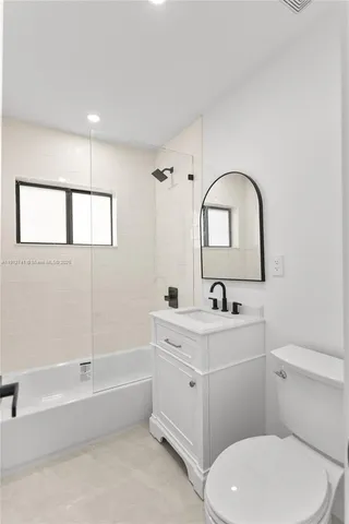 a bathroom with a sink a toilet and a bathtub