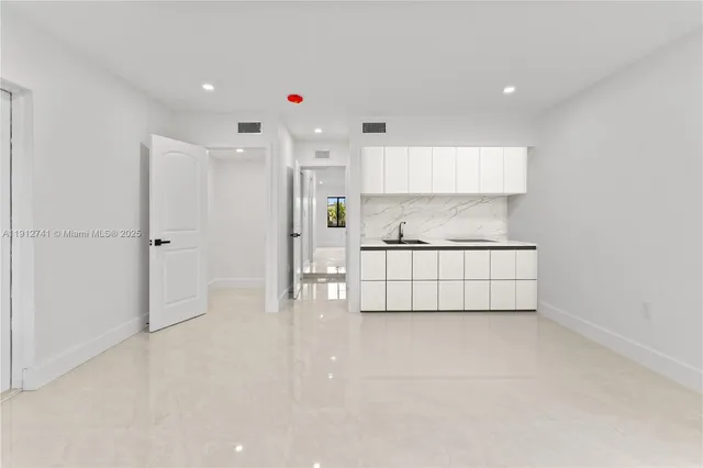 a living room with white walls and white walls