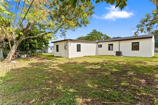 an aerial view of a house with a garden and swimming pool