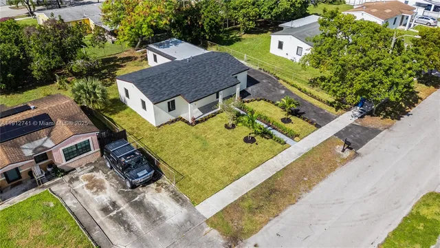 an aerial view of residential houses with outdoor space