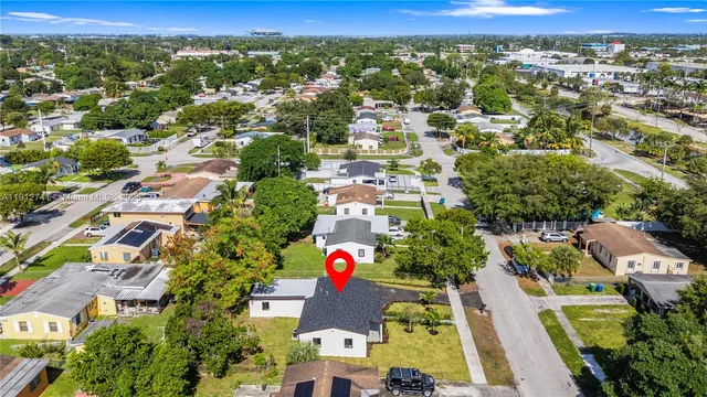 a view of a house with wooden fence