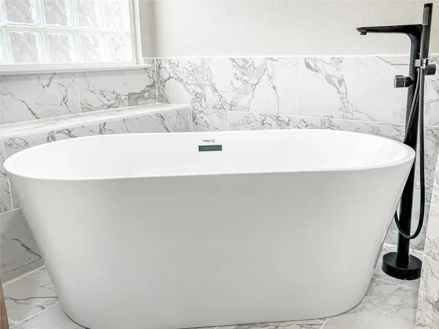 a white bath tub sitting in a bathroom