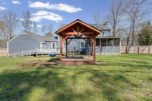 a view of a backyard with a garden and swimming pool