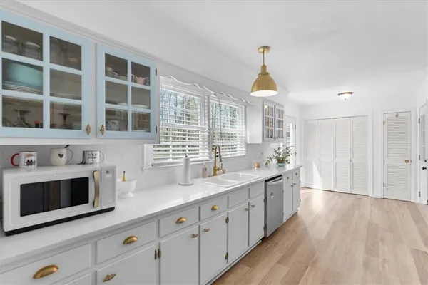 a kitchen with stainless steel appliances a stove sink and cabinets