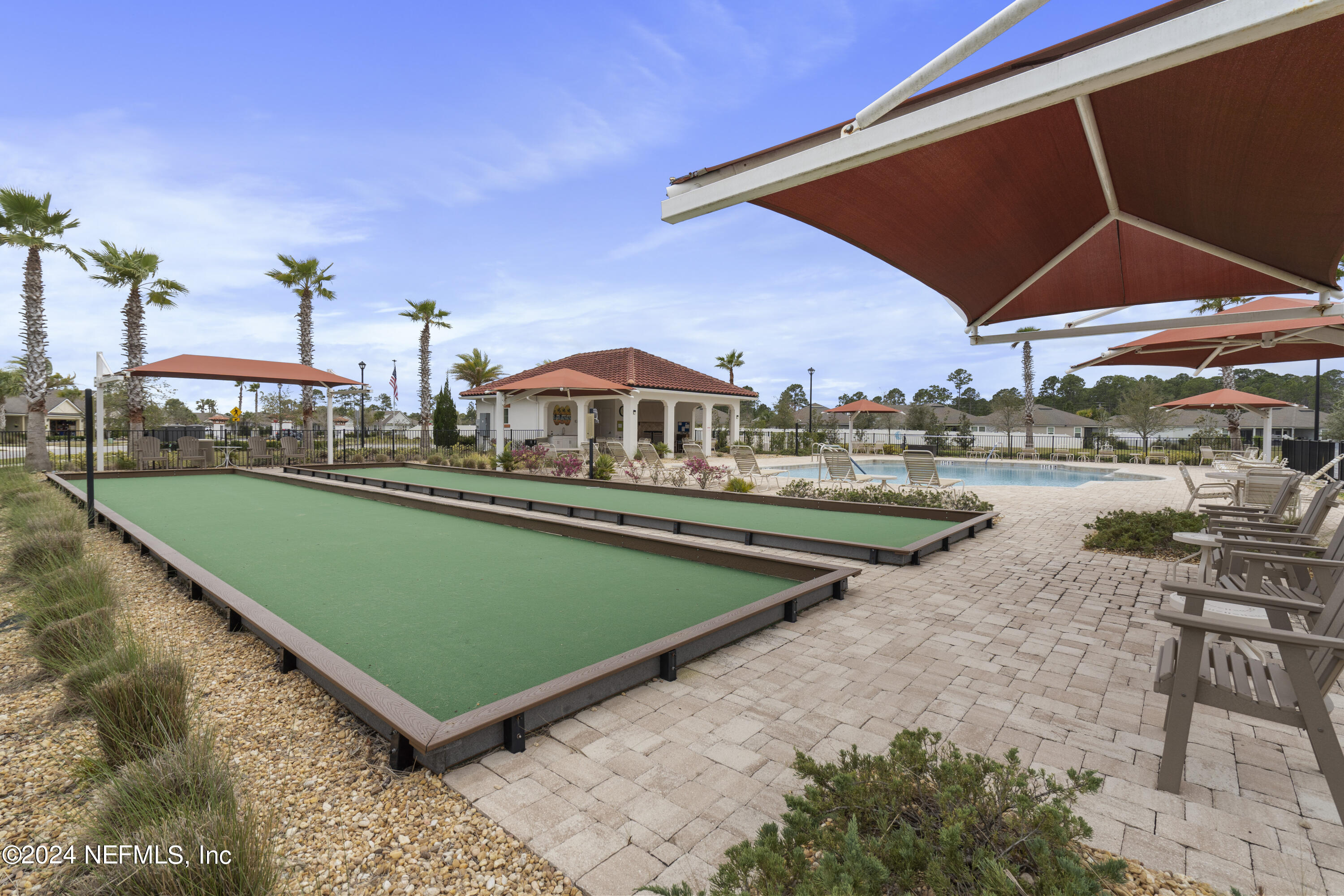 548 Palace Drive St. Augustine, FL 32084 - Photo 11 of 19 a view of a swimming pool with lawn chairs under an umbrella