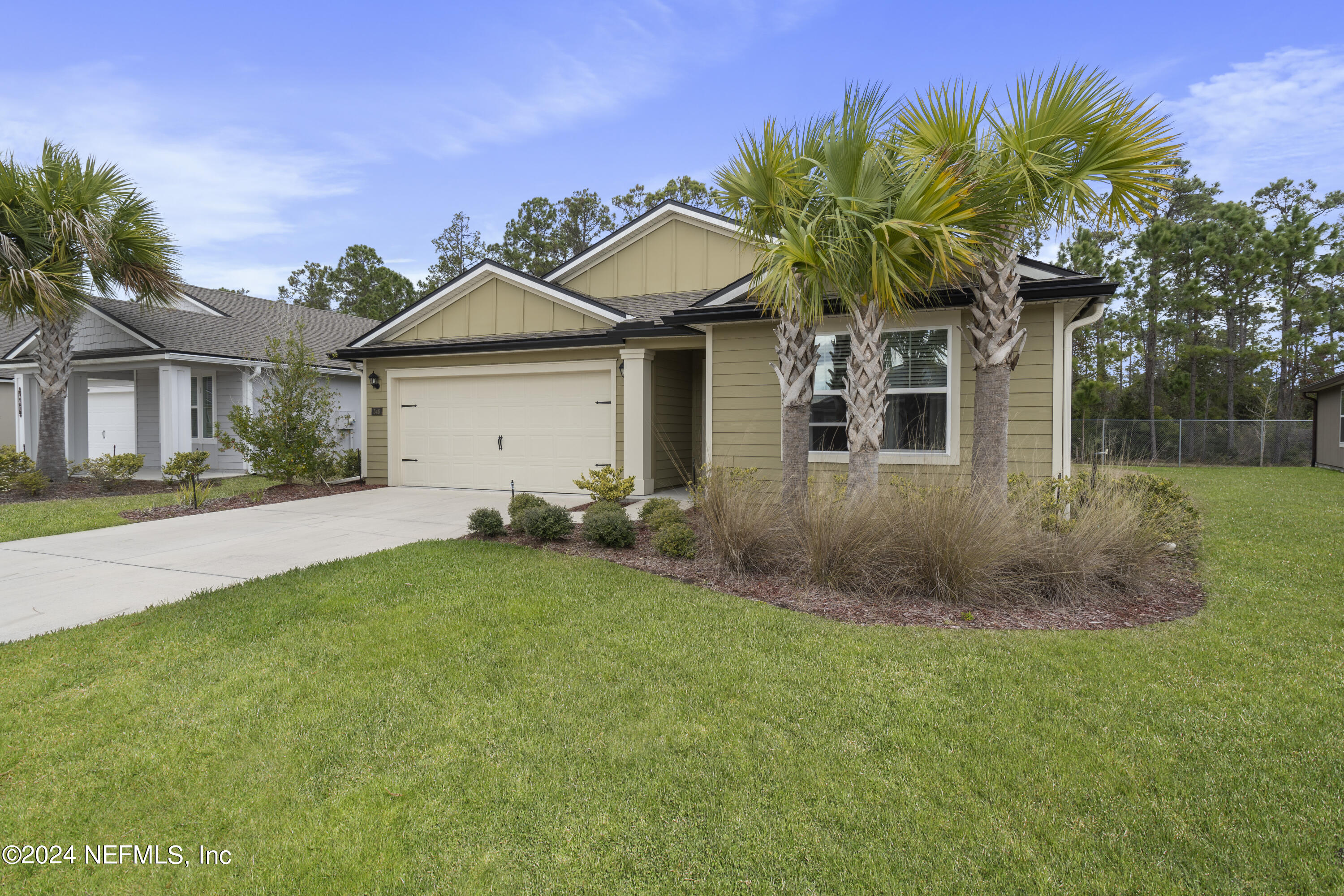 548 Palace Drive St. Augustine, FL 32084 - Photo 14 of 19 a front view of a house with a garden and yard