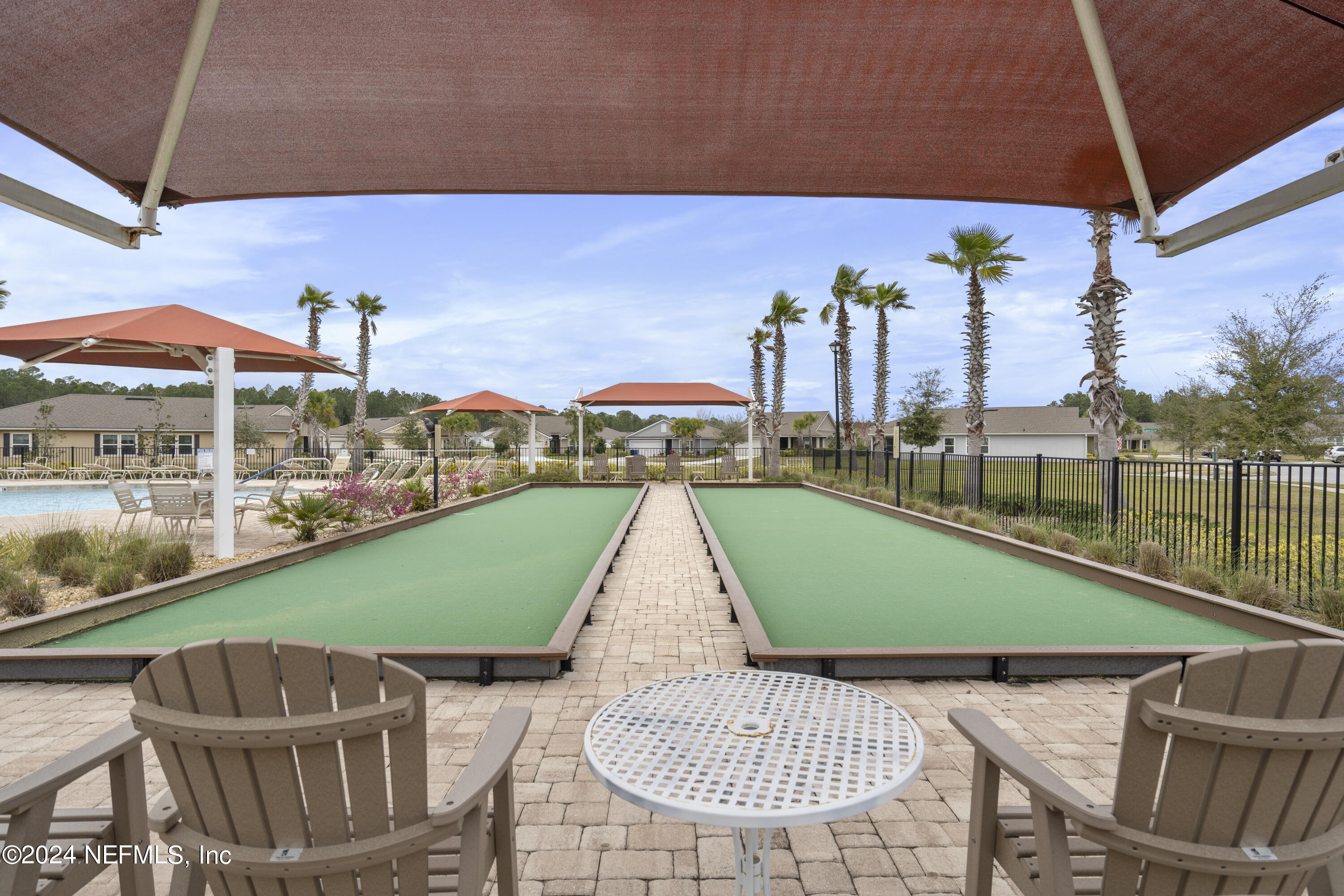 548 Palace Drive St. Augustine, FL 32084 - Photo 19 of 19 a view of a patio with a table and chairs under an umbrella
