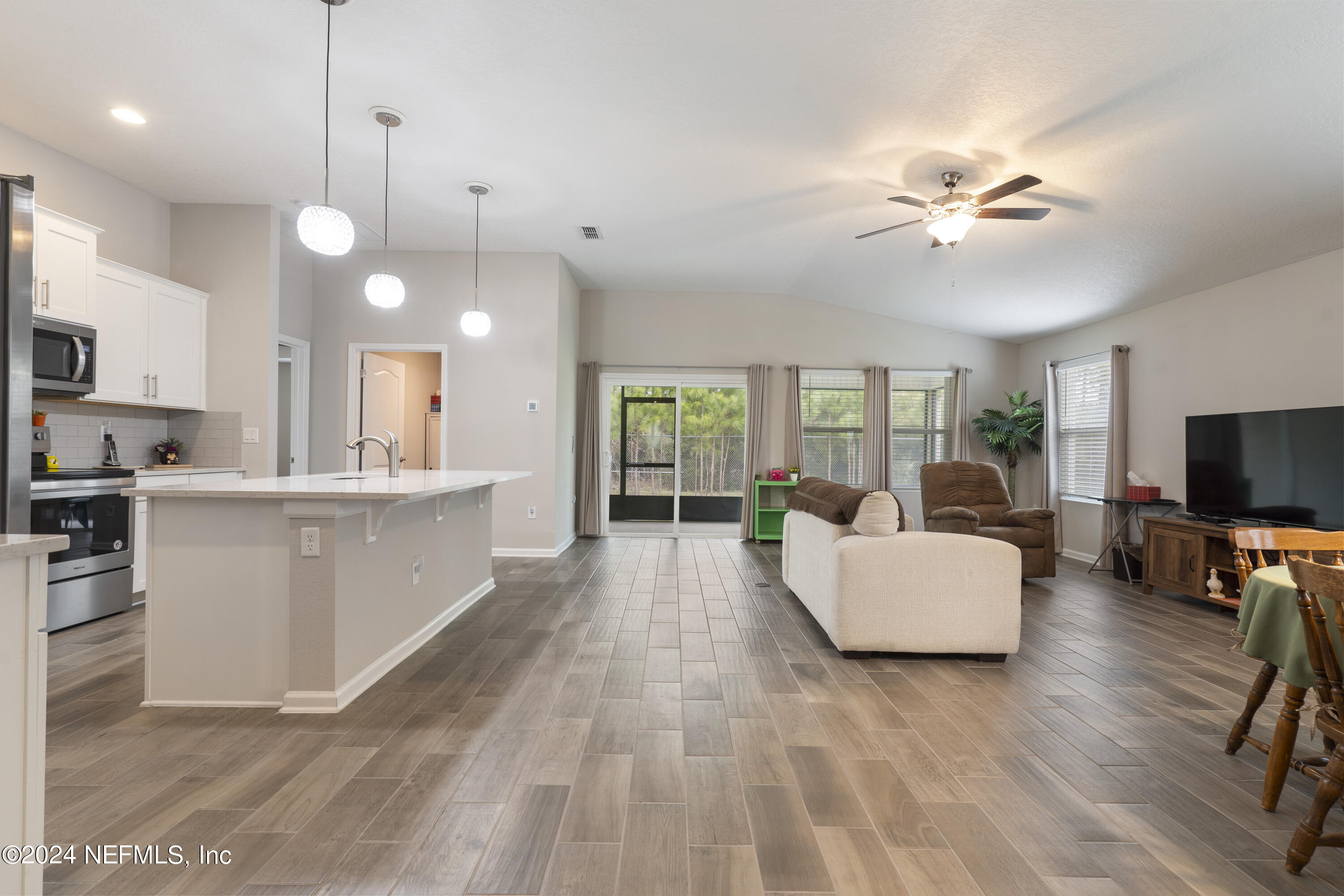 548 Palace Drive St. Augustine, FL 32084 - Photo 2 of 19 a living room with furniture a flat screen tv and a large window