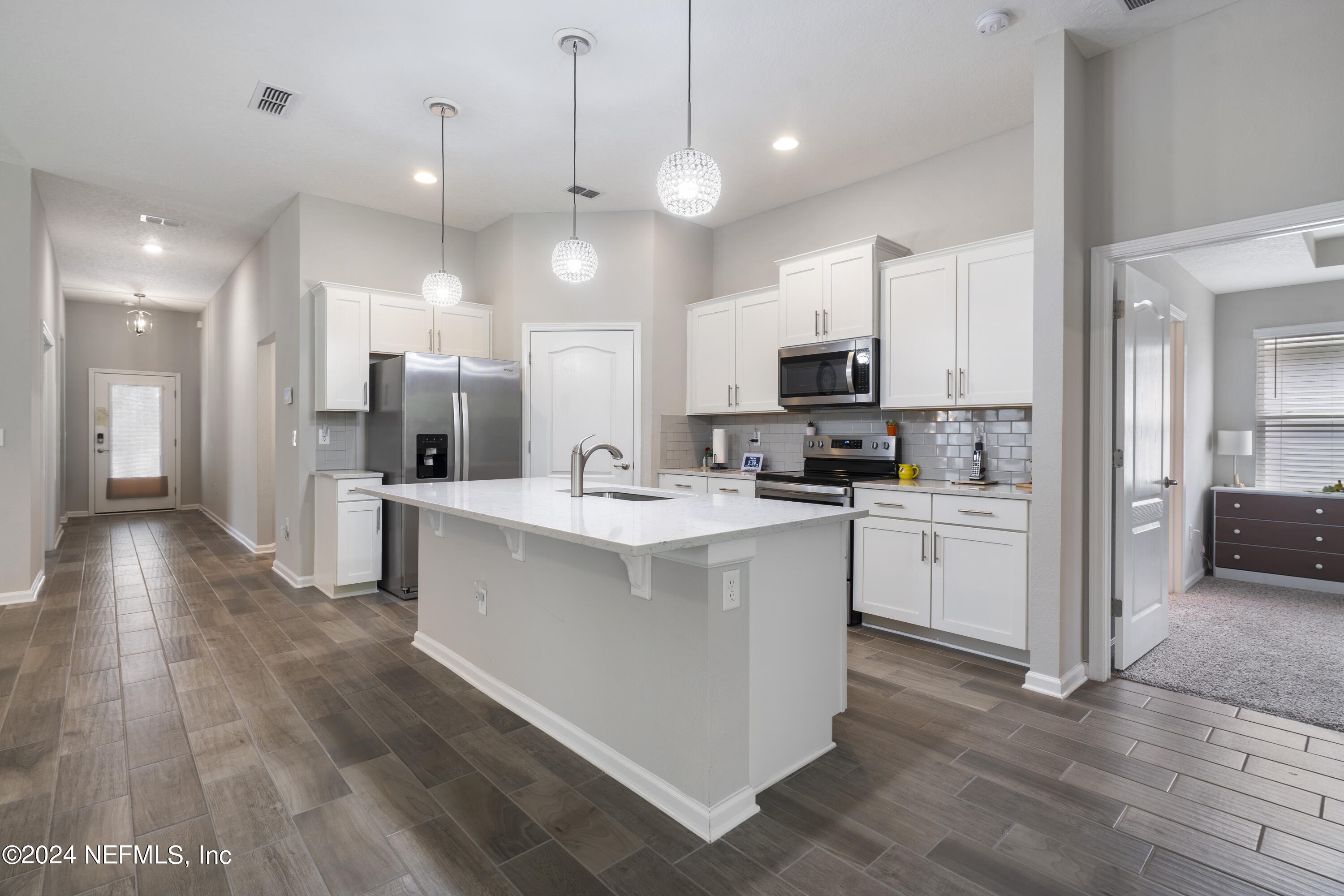 548 Palace Drive St. Augustine, FL 32084 - Photo 3 of 19 a large kitchen with kitchen island a sink and a stove
