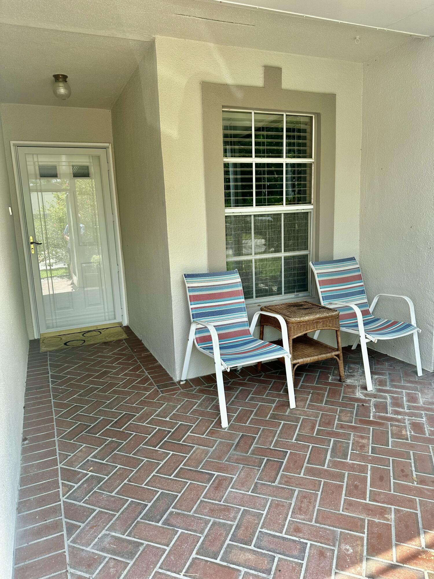 18900 Stewart Circle, Unit 7 Boca Raton, FL 33496 - Photo 13 of 23 a backyard of a house with table and chairs