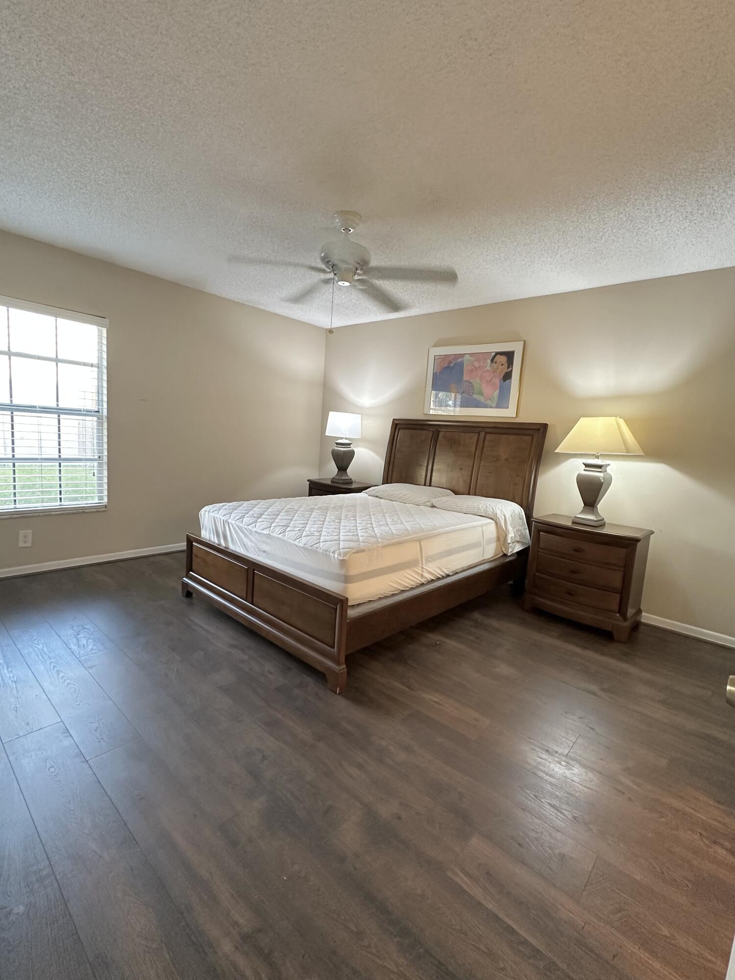18900 Stewart Circle, Unit 7 Boca Raton, FL 33496 - Photo 5 of 23 a spacious bedroom with a bed and a window
