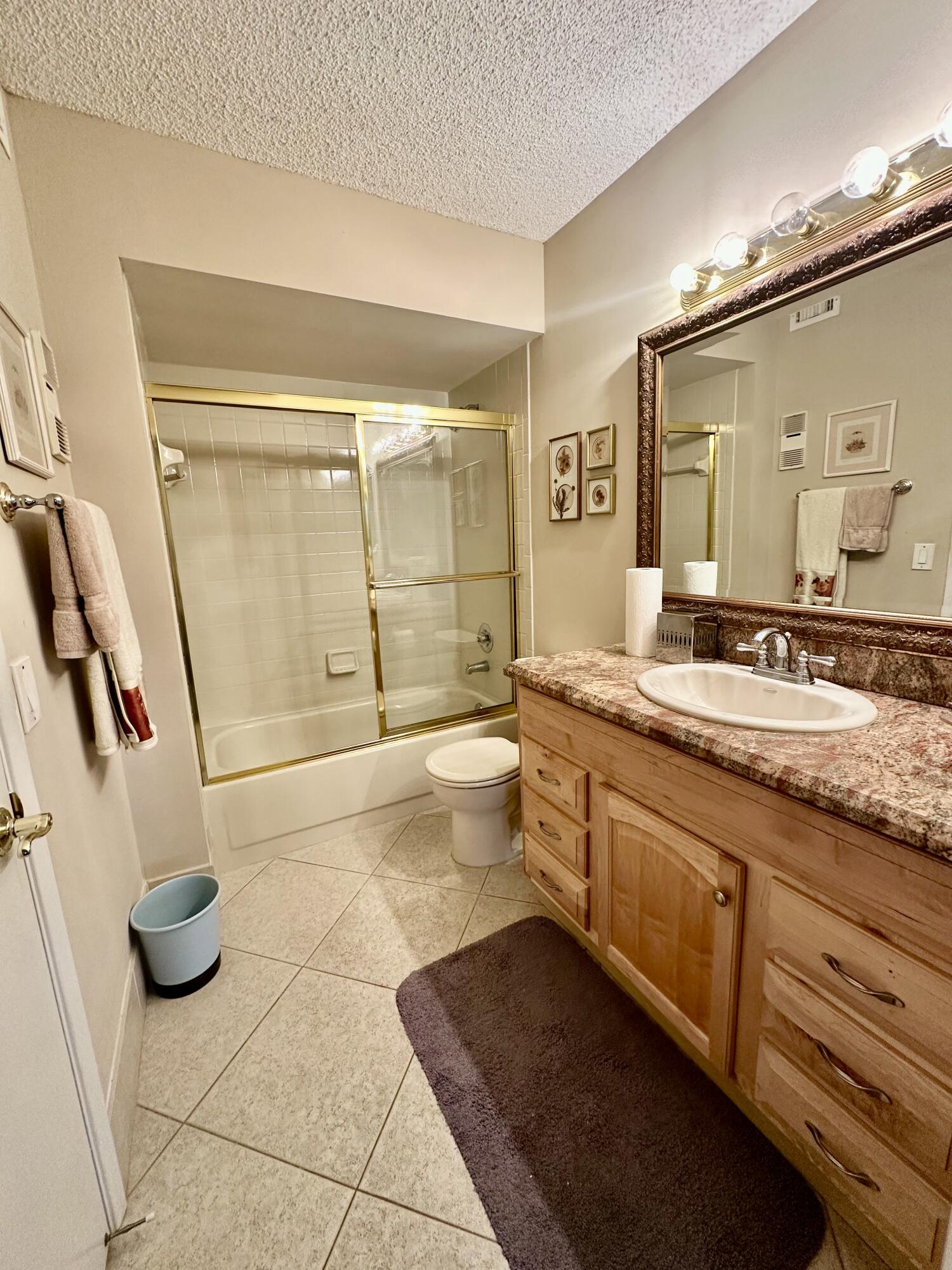 18900 Stewart Circle, Unit 7 Boca Raton, FL 33496 - Photo 9 of 23 a spacious bathroom with a granite countertop sink a toilet a mirror and shower