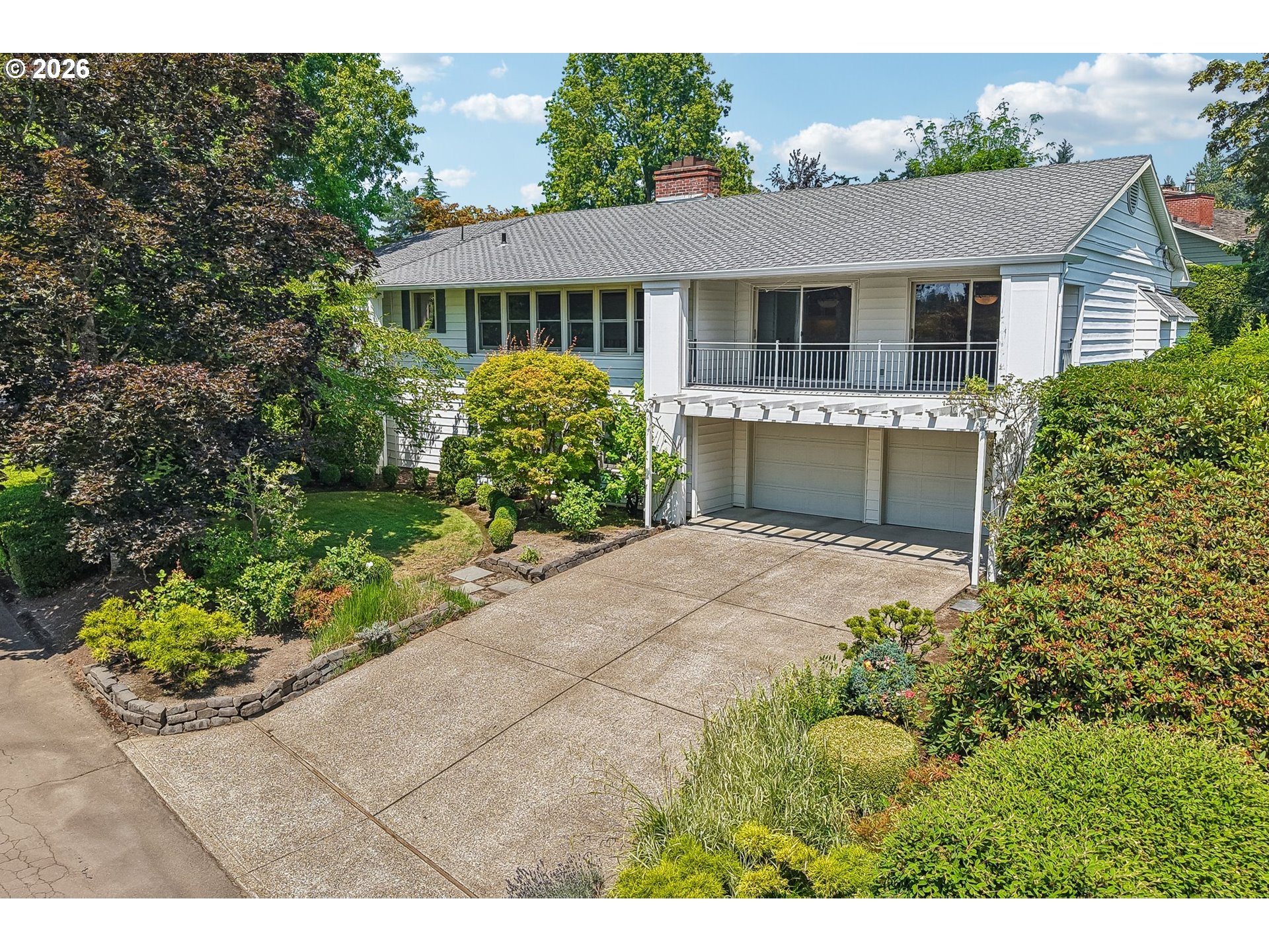 7600 Southwest Northvale Way Portland, OR 97225 - Photo 45 of 46 a front view of a house with a yard and potted plants