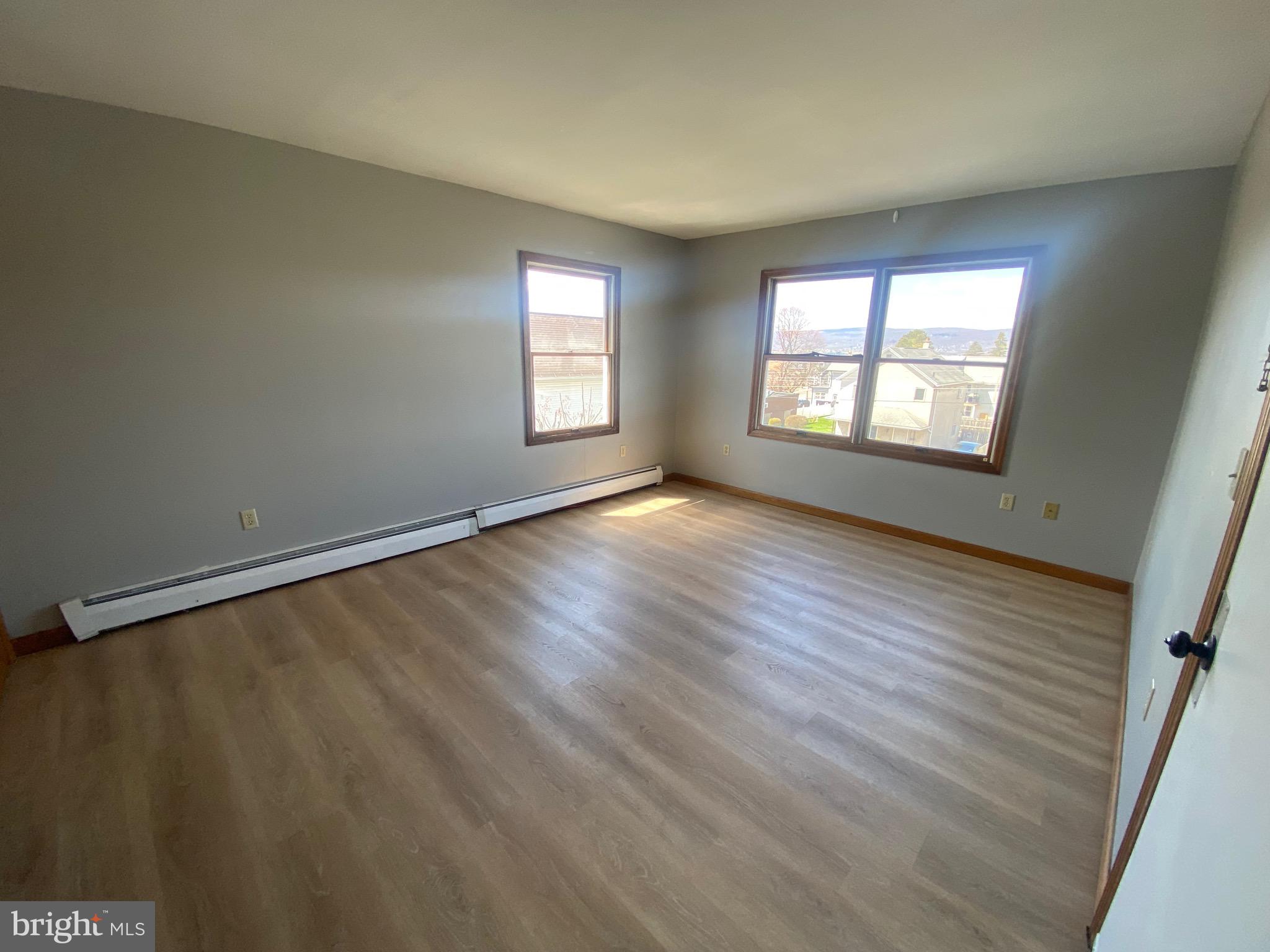 113 Frank Street, Unit 6 Dunmore, PA 18512 - Photo 2 of 6 an empty room with wooden floor and windows