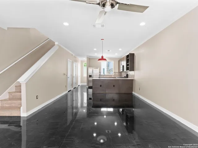 a kitchen with kitchen island a sink and wooden floor