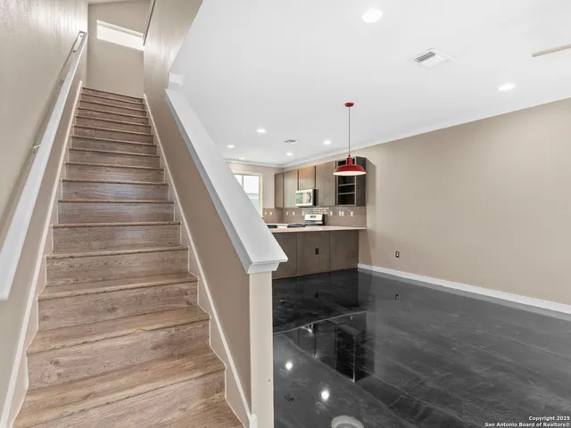 a view of entryway and hall with wooden floor