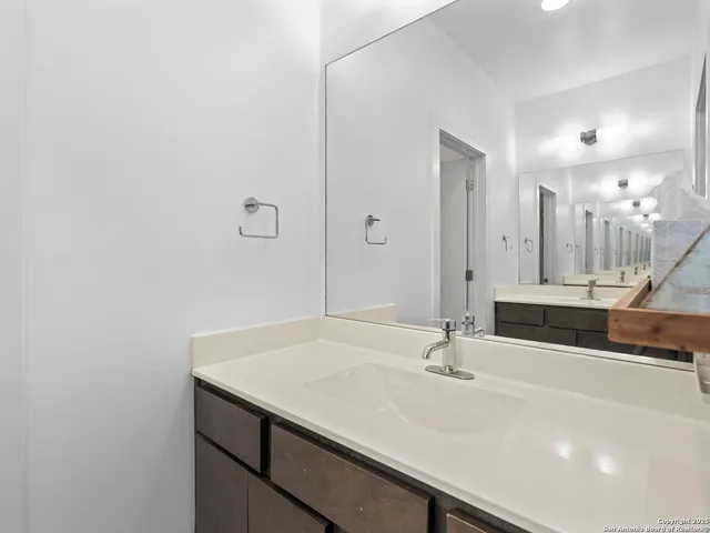 a bathroom with a sink and a mirror